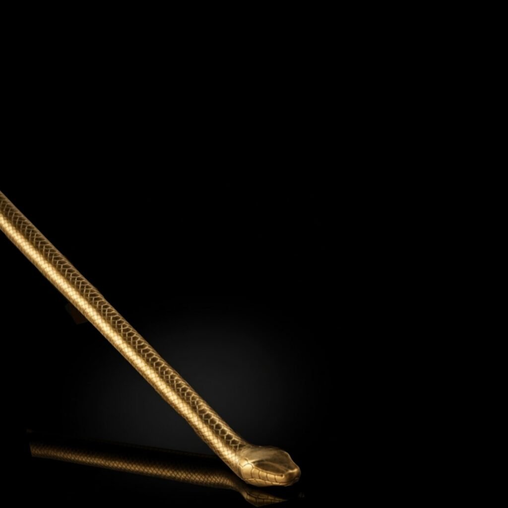 Luxury brass handrail for staircases with a smooth ergonomic form, photographed in a black studio with soft reflective lighting.
