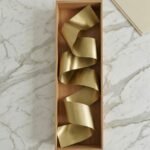 brass wall decor secured in custom wooden packaging